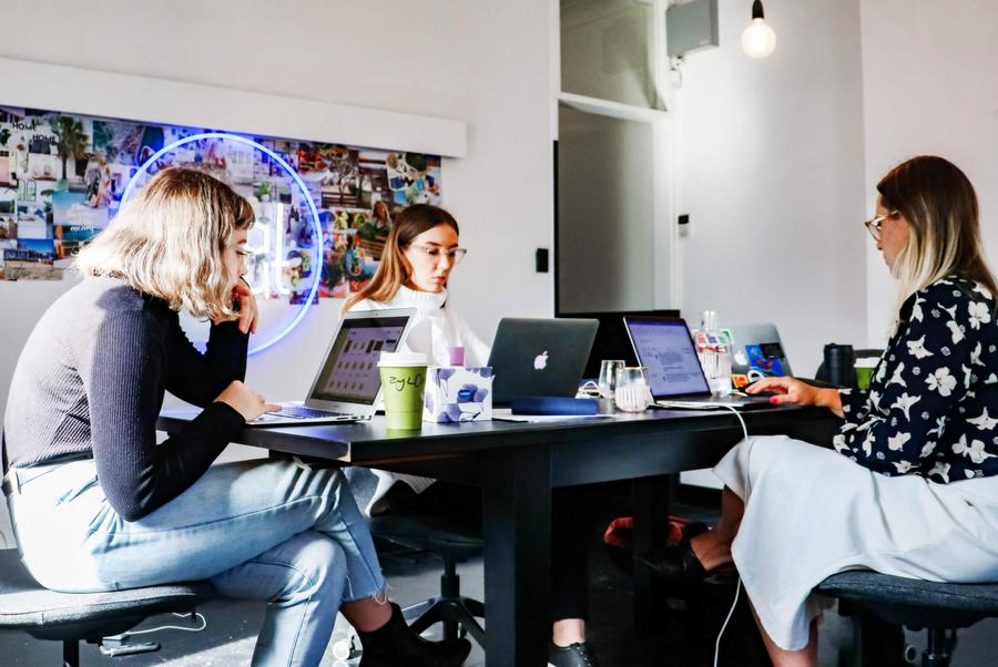 Women sitting around a desk, discussing marketing plans