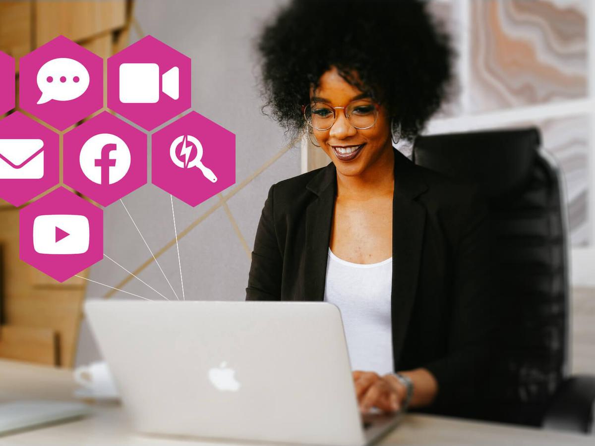 Female sitting at a laptop with various digital channels overlaid.
